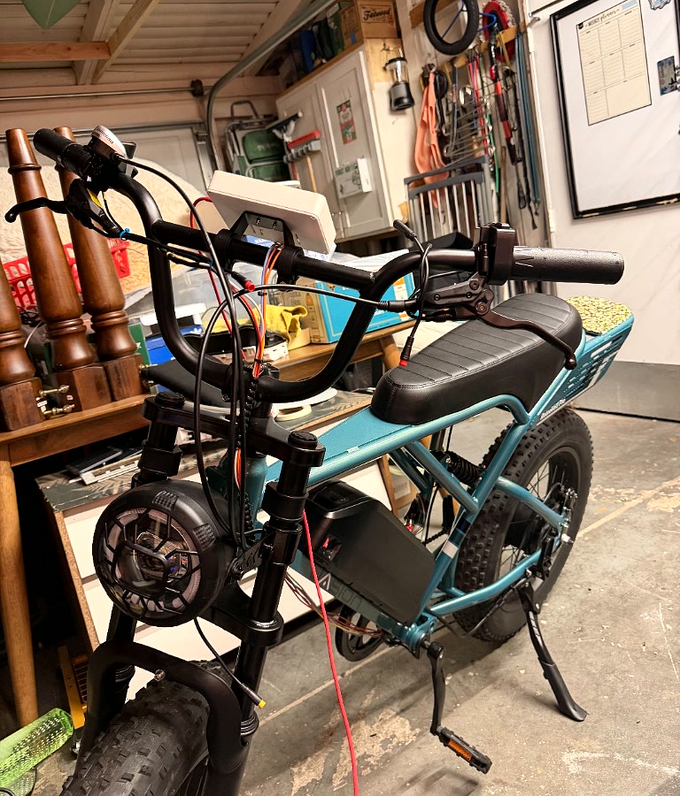 The Jasion Retrovolt Pro fat-tire ebike in the garage with custom ESP32-S3 touchscreen display mounted on handlebars.